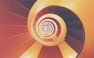 Spiral staircase with red background.