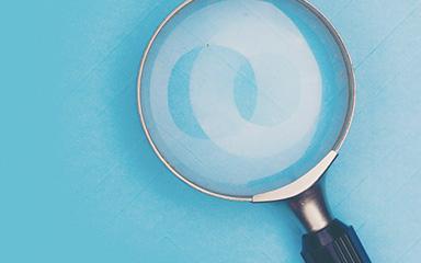Magnifying glass with a blue background.