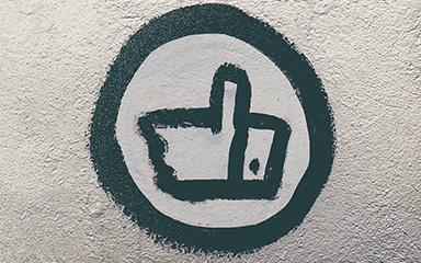 Thumbs up sign in paint on a white background.